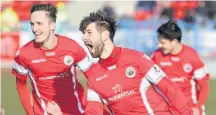  ??  ?? Strike Darren Smith celebrates his 24th goal of the season with Ross Kavanagh