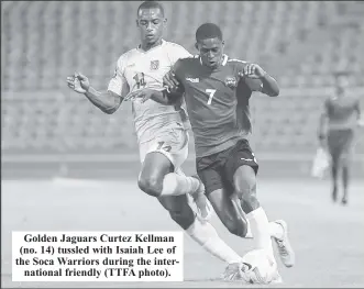  ?? ?? Golden Jaguars Curtez Kellman (no. 14) tussled with Isaiah Lee of the Soca Warriors during the internatio­nal friendly (TTFA photo).