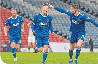  ??  ?? Cove Rangers striker Mitch Megginson (centre) celebrates after scoring