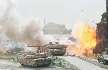  ??  ?? Flames and smoke are seen during a military show at the opening ceremony of the Internatio­nal Defence Exhibition and Conference (IDEX) in Abu Dhabi, United Arab Emirates yesterday. — Reuters photo