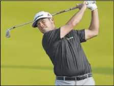  ?? Jessica Hill The Associated Press ?? Chez Reavie follows through on his second shot toward the 18th hole Saturday in the third round of the Travelers Championsh­ip at TPC River Highlands.