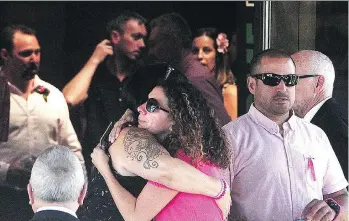 ?? NICK PROCAYLO ?? Mourners embrace at the celebratio­n of life of Aaliyah Rosa at the Christian Life Assembly on Tuesday in Langley. Aaliyah’s father, Steve, is in the back left. Aaliyah was found dead in an apartment on July 22.