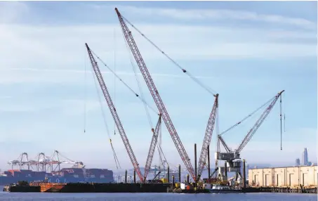  ?? Paul Chinn / The Chronicle ?? Cranes are docked at the Port of Oakland, near the site of a proposed facility to receive and store coal for shipment overseas.