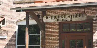  ?? Leslie Hutchison / Hearst Connecticu­t Media ?? New tenants are leasing space at the 10 Bridge St. building on the bank of the Mad River on Main Street.