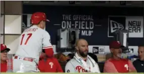  ?? GREGORY BULL — THE ASSOCIATED PRESS ?? Rhys Hoskins gets the silent treatment from his teammates after hitting his first major league home run in the fourth inning for the Phillies against the San Diego Padres on Monday.