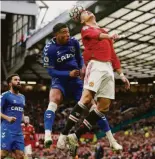  ?? Dave Thompson / Associated Press ?? Everton’s Ben Godfrey and Manchester United’s Cristiano Ronaldo go for a header.