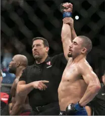  ?? Erik Verduzco ?? Las Vegas Review-journal @Erik_verduzco Robert Whittaker, right, is announced the winner by unanimous decision against Yoel Romero in the interim middleweig­ht title bout of UFC 213 on Saturday at T-mobile Arena.