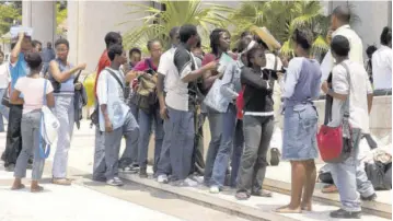  ??  ?? Students wait in line at the Students’ Loan Bureau to apply for financial assistance. Jamaica Teachers’ Associatio­n President Dr Garth Anderson has proposed that the loan repayment period be treated as a mortgage and that the bureau be placed under the purview of the Ministry of Education, Youth and Informatio­n.