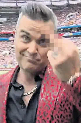  ?? Pictures: MAXIM ZMEYEV/AFP ?? Robbie Williams gestures at the camera after his memorable performanc­e