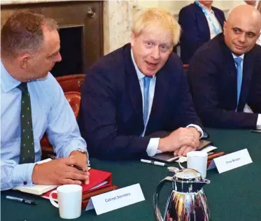  ??  ?? Let’s go: Boris Johnson with Mark Sedwill and Sajid Javid at his Cabinet’s first meeting