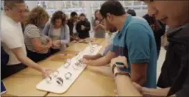  ?? ASSOCIATED PRESS ?? Customers look at Apple Watches at an Apple store in New York. A huge study suggests the Apple Watch sometimes can detect a worrisome irregular heartbeat. But experts say more work is needed to tell if using wearable technology to screen for heart problems really helps.