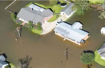  ?? BILL FEIG/THE ADVOCATE VIA AP, POOL ?? Houses surrounded by floodwater­s are seen Oct. 10 in the aftermath of Hurricane Delta in Welsh, La. Hurricane Delta cost $2.9 billion in the United States and was linked to six deaths in the U.S. and Mexico, according to a report from the National Hurricane Center.