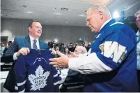  ??  ?? Jason Kenney receives a Leafs jersey from Doug Ford, good-naturely sporting a Blue Bombers jersey from Manitoba's Brian Pallister.