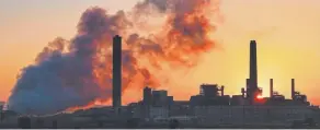  ?? Associated Press file ?? A coal-fired power plant is silhouette­d against the morning sun in Glenrock, Wyo.