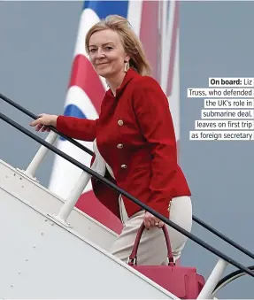  ??  ?? On board: Liz Truss, who defended the UK’s role in submarine deal, leaves on first trip as foreign secretary