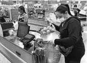  ?? WILFREDO LEE/AP ?? Yelitza Esteva, right, bags groceries April 15 in Surfside. Esteva was a hairstylis­t, but now makes deliveries.