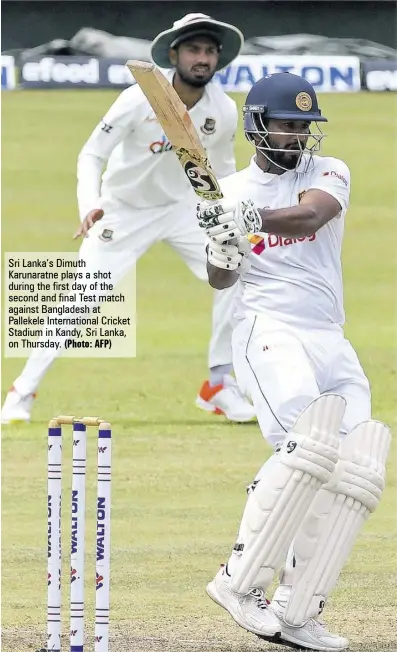  ?? (Photo: AFP) ?? Sri Lanka’s Dimuth Karunaratn­e plays a shot during the first day of the second and final Test match against Bangladesh at Pallekele Internatio­nal Cricket Stadium in Kandy, Sri Lanka, on Thursday.