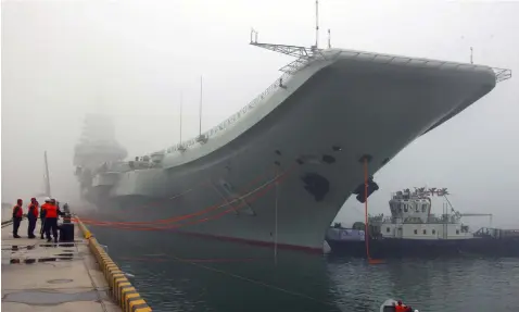  ?? (Wu Dengfeng/Xinhua via AP, File) ?? In this Feb. 27, 2013 file photo released by China's Xinhua news agency, China's first aircraft carrier, the Liaoning, is anchored in the northern port in Qingdao, east China's Shandong Province. Taiwan's defense ministry said China's sole aircraft...