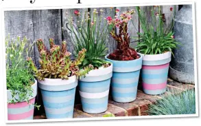  ?? ?? SUNNY: A bright deckchair with boardwalk and some painted pots, left, will give the beach feel