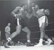  ?? THE ASSOCIATED PRESS ?? Floyd Paterson delivers a left hook to the chin of Muhammad Ali during the second round of their heavyweigh­t title fight in Las Vegas on Nov. 22, 1965.