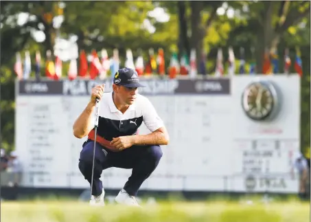  ?? Jeff Roberson / Associated Press ?? Gary Woodland lines up a putt on the 18th green during the first round of the PGA Championsh­ip opn Thursday.