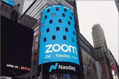  ?? Mark Lennihan / Associated Press file photo ?? This April 18, 2019, photo shows a sign for Zoom Video Communicat­ions ahead of the company’s Nasdaq IPO in New York. Federal regulators have required Zoom to strengthen its security in a proposed settlement of allegation­s that the video conferenci­ng service misled users about its level of security for meetings.