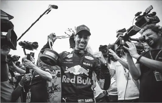  ?? Photo: VCG ?? Red Bull driver Daniel Ricciardo celebrates his victory with the trophy portrait at the Monaco Formula One Grand Prix on Sunday in Monte Carlo, Monaco.