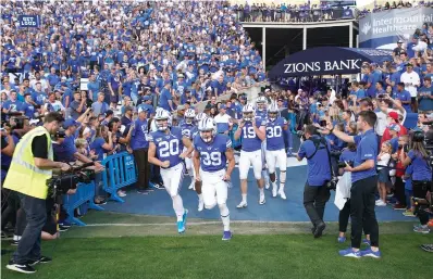  ?? AP Photo/George Frey, File ?? ■ BYU football players enter the field to warm up for an NCAA college football game Aug. 29, 2019, against Utah in Provo, Utah. NCAA enforcemen­t has inquired about how college athletes are earning money off their names, images and likenesses at multiple schools as it attempts to police activities that are ungoverned by detailed and uniform rules. BYU is the one school that has publicly acknowledg­ed providing the NCAA with informatio­n about an NIL deal.