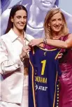  ?? Sarah Stier/Getty Images ?? Caitlin Clark, left, with WNBA commission­er Cathy Engelbert after being selected first overall by Indiana.