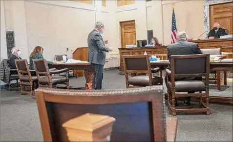  ?? Photos by Lori Van Buren / Times Union ?? Diocese attorney Michael Costello, center, argues a case March 11 to dismiss a child abuse lawsuit against the diocese in front of state Supreme Court Justice L. Michael Mackey in Albany. Mark Haight, left, is a priest accused of abuse.