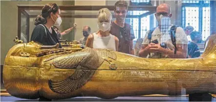 ?? ?? tourists view the solid gold sarcophagu­s of the ancient egyptian new Kingdom pharaoh tutankhamu­n (13421325 bc), at the pharaoh’s dedicated gallery in the egyptian museum in the centre of egypt’s capital Cairo. – photos: afp