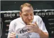  ?? PATRICK TEHAN — STAFF FILE PHOTO ?? Competitiv­e eating champion Joey Chestnut competes in a taco eating contest in August during the 2nd Annual Chacho’s Taco Festival in St. James Park in downtown San Jose.