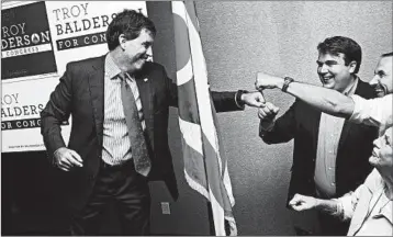  ?? JUSTIN MERRIMAN/GETTY ?? GOP candidate Troy Balderson celebrates his slim lead over Danny O’Connor on Tuesday night in Newark, Ohio.