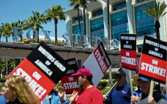  ?? ASHLEY LANDIS/ASSOCIATED PRESS ?? Members of the the Writers Guild of America picketed outside of Fox Studios Tuesday, starting the first Hollywood strike in 15 years.