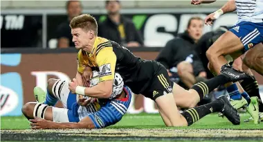  ?? PHOTO: MARTY MELVILLE/PHOTOSPORT. ?? Jordie Barrett prepares to rip the ball away from Stormers No.8 Nizaam Carr and score a miraculous try at Westpac Stadium.