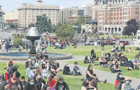  ??  ?? People on the B.C. legislatur­e lawn listen to speakers at an event recognizin­g the solidarity between Black and Indigenous People of Colour.