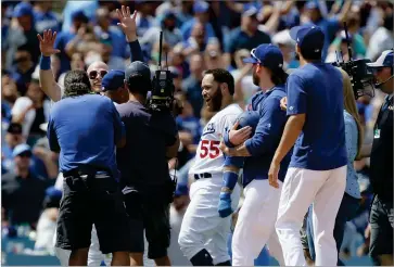  ?? AP PHOTO BY ALEX GALLARDO ?? Los Angeles Dodgers’ Russell Martin, center, reacts with head coach Dave Roberts, obscured, after hitting the game winning two-run single against the St. Louis Cardinals during the ninth inning of a baseball game in Los Angeles, Wednesday, Aug. 7. The Dodgers won 2-1.