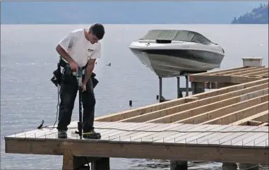  ?? GARY NYLANDER/The Daily Courier ?? Jay Whiteside of Shoreline Pile Driving rebuilds a dock along the beach near Abbott Street and Vimy Avenue in Kelowna.