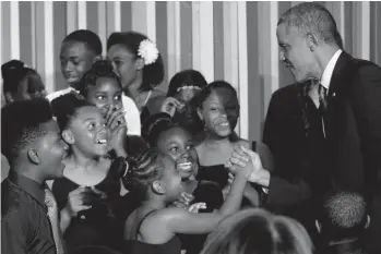  ??  ?? US President Barack Obama greets student performers on stage during the White House Talent Show in the East Room of the White House in Washington on Tuesday. The White House Talent Show was hosted by First Lady Michelle Obama and the President’s Committee on the Arts and the Humanities ( PCAH). —