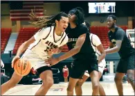  ?? (Pine Bluff Commercial/I.C. Murrell) ?? Terrion Burgess of Benton (left) drives toward the basket against Nigel Thomas of McDonough on Dec. 27, 2023, at the King Cotton Holiday Classic. Alabama recently offered the 4-star recruit Burgess a scholarshi­p, adding to his list of offers which includes the University of Arkansas, Auburn, Georgia Tech, Oklahoma and Texas Tech.