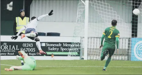  ??  ?? GOAL Roarie Deacon leaps over keeper Brad House with his shot on the way into the net for Hawks’ opening goal