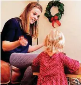  ?? [PHOTO BY PAUL
HELLSTERN, THE OKLAHOMAN] ?? LEFT: Ashley Kehl discusses being a foster parent as she cares for a child at her home in Oklahoma City.