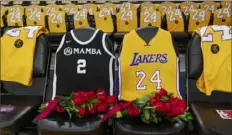  ?? The New York Times ?? Flowers and jerseys were placed on courtside seats at Staples Center Friday night in remembranc­e of Kobe Bryant and daughter Gianna. The Lakers played their first game since their deaths, but not before a pregame ceremony that echoed around the world.