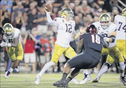  ?? Andy Lyons / Getty Images ?? Fighting Irish QB Ian Book throws against Louisville during Monday’s game. Book passed for 193 yards and a touchdown in Notre Dame’s 35-17 victory. For a full report, go to http://timesunion.com/sports.