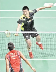  ?? — AFP photo ?? China’s Chen Long plays a return to compatriot Lin Dan during their men’s singles quarterfin­al at 2013World Championsh­ips in Guangzhou, south China’s Guangdong province.