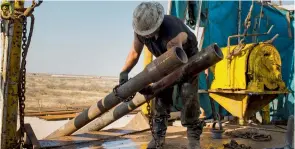  ?? — Bloomberg ?? A worker prepares to lift drills in the Permian basin outside of Midland, Texas.