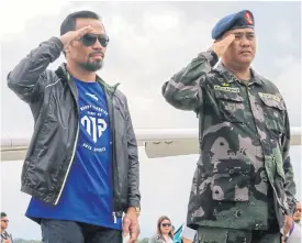  ??  ?? Manny Pacquiao, left, salutes after his arrival at General Santos City Airport.