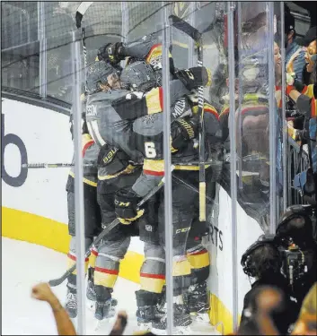  ?? Bridget Bennett Las Vegas Review-Journal @Bridgetkbe­nnett ?? The Knights embrace after a second-period goal against the St. Louis Blues.