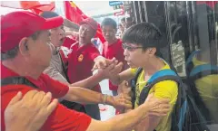  ??  ?? FLASHPOINT: Pro-Beijing supporters scuffle with a member of the public during a rally yesterday in the Tsim Sha Tsui district of Hong Kong to celebrate China’s National Day.