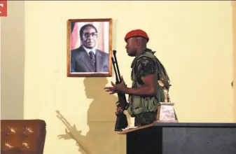  ?? Tsvangiray­i Mukwazhi / Associated Press ?? A portrait of former Zimbabwean President Robert Mugabe is seen on the set of a play in Harare that dramatizes the events leading to Mugabe’s resignatio­n after 37 years in power.